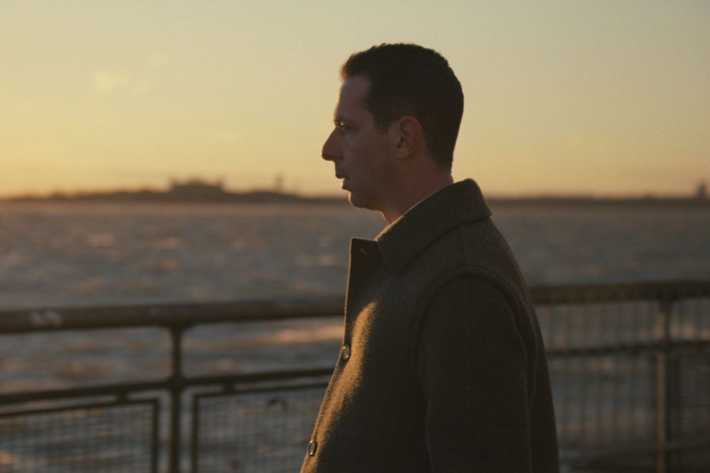 Kendall sitting alone by the ocean