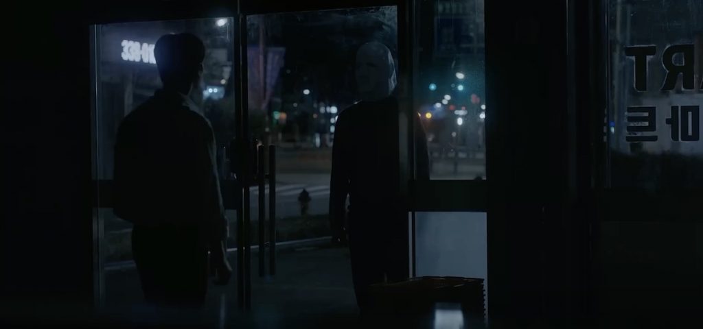 Mysterious masked figure appears outside the door