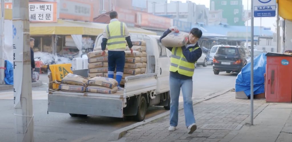 Ho-rang works at a construction site unloading cement